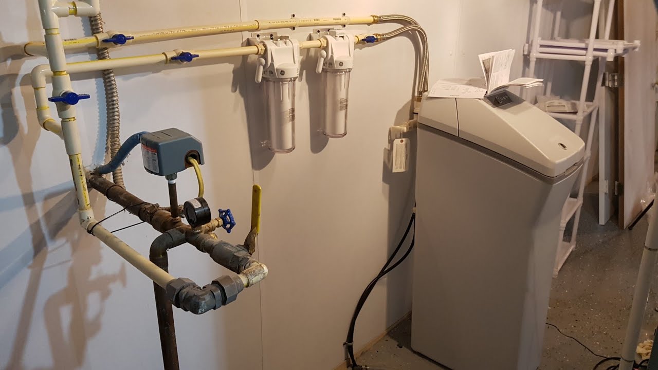 Water softener installation technician at work